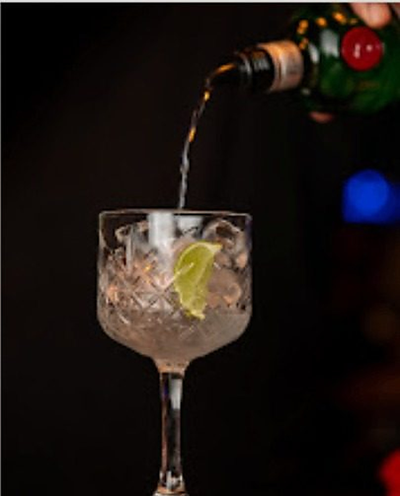 Gin poured over ice into a crystal glass