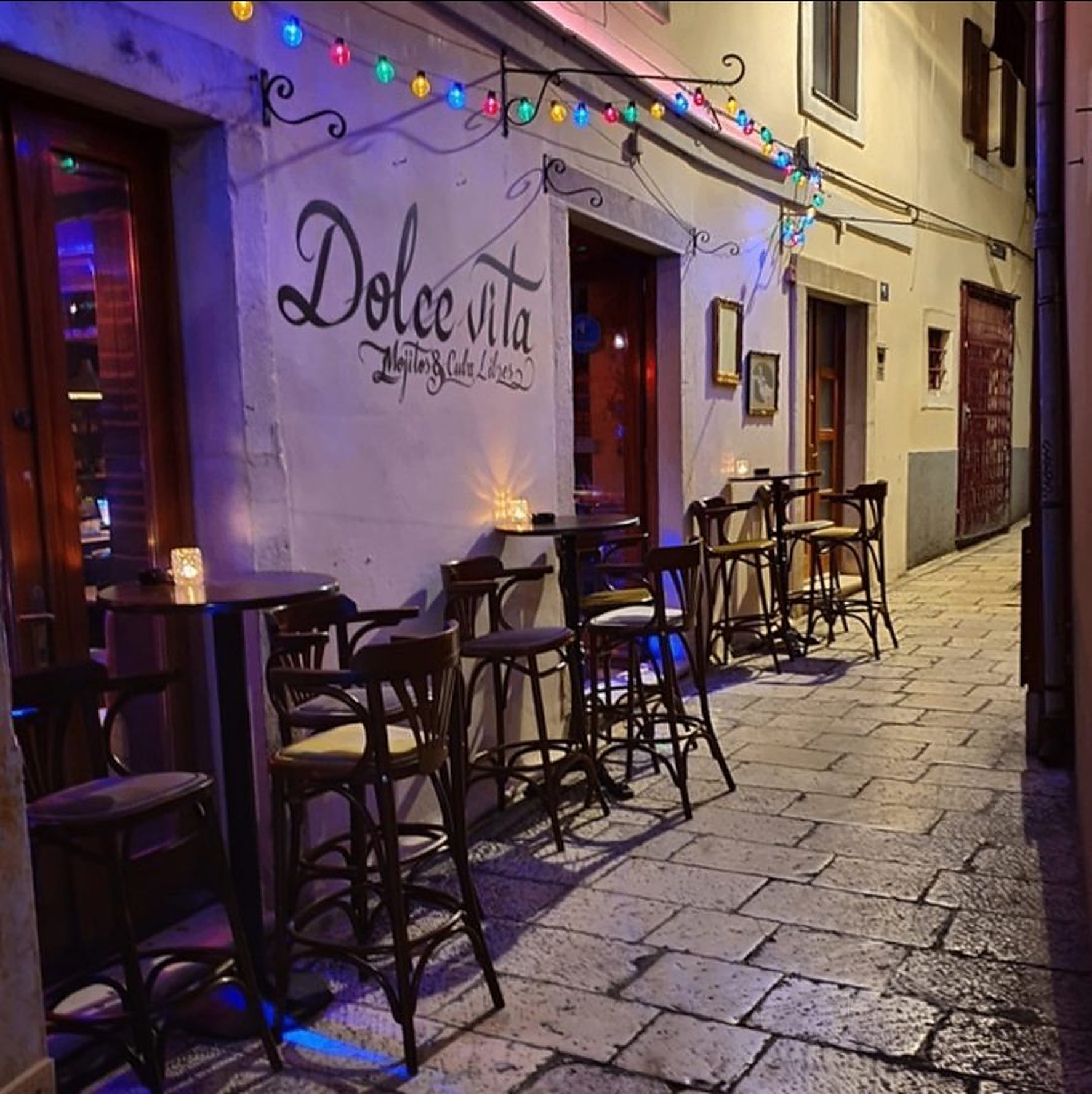 Dolce Vita terrace at night in a narrow Zadar alley under string lights