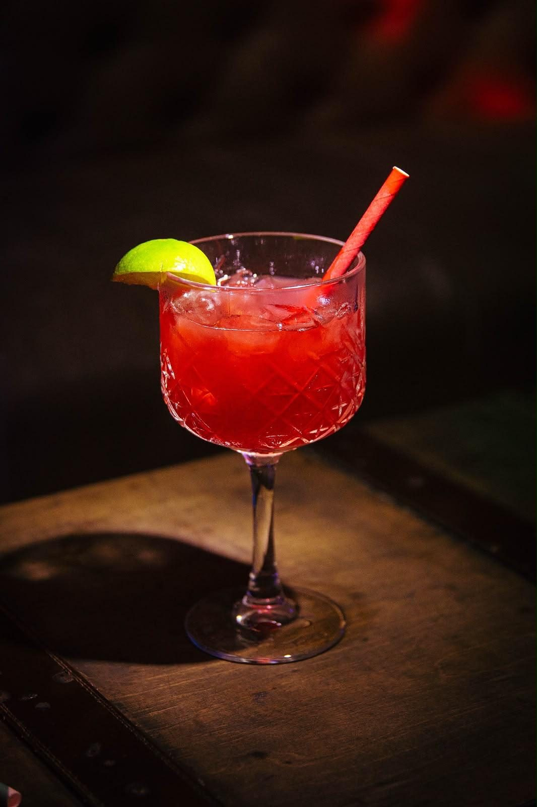 Red cocktail served in a crystal coupe